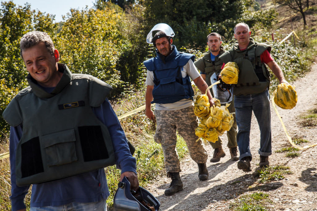 Deminers from BH MAC withdraw security tape after successfully clearing a small area near Visoko (from left to right: BH MAC inspector Sinisa, team leader Marko, deminer Nebojsa, operative officer Savo).