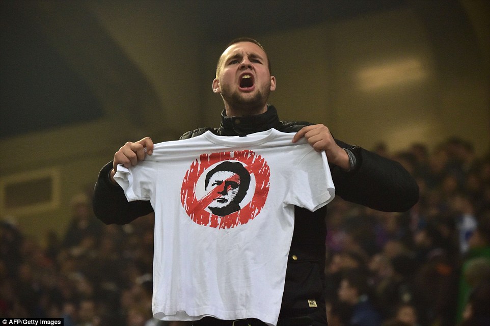 "A Croatia fan holds a T-shirt with a portrait of Zdravko Mamic, the head of Dynamo Zagreb football club, during the match" (Photo credit: AFP/Getty/©)