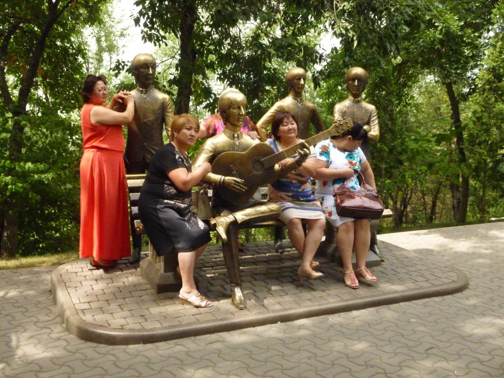 A group of Kazakhstani women have their picture taken at the Beatles monument in Kok Tebe, Almaty.