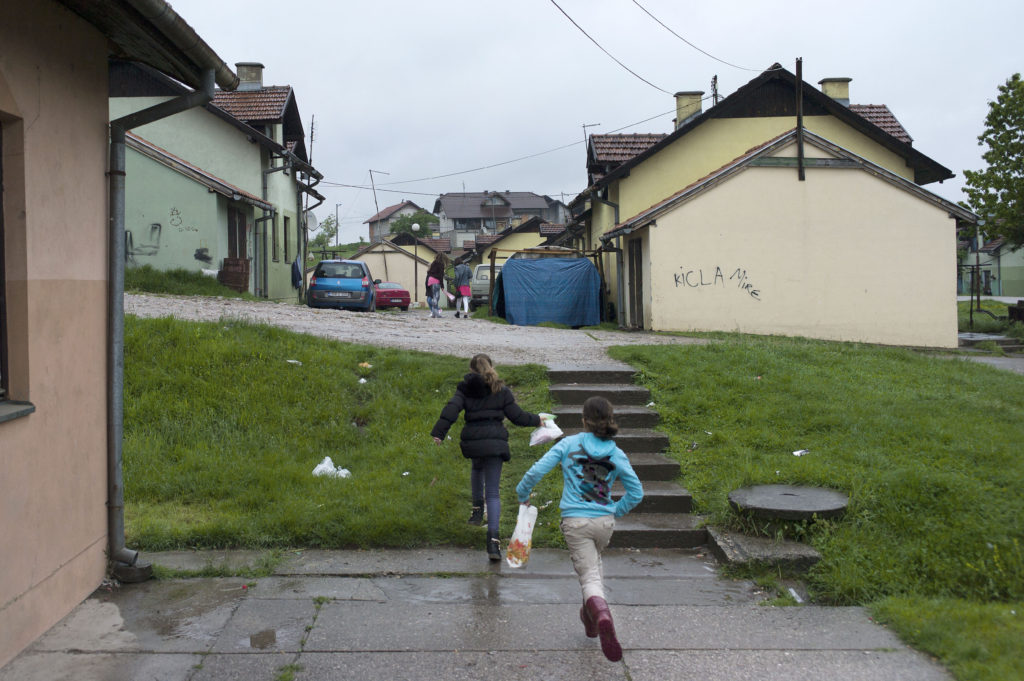 Children run through the pre-fab UNHCR houses in the town of Mihatovići, home to approximately 10,000 Bosnian refugees, a majority from Srebrenica. (Photo credit: Chris Bobyn)