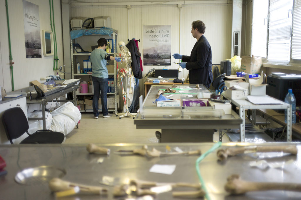 Dr. Dragana Vucetic with a colleague in the container labs of Tuzla’s Podrinje Identification Project. (Photo credit: Chris Bobyn)